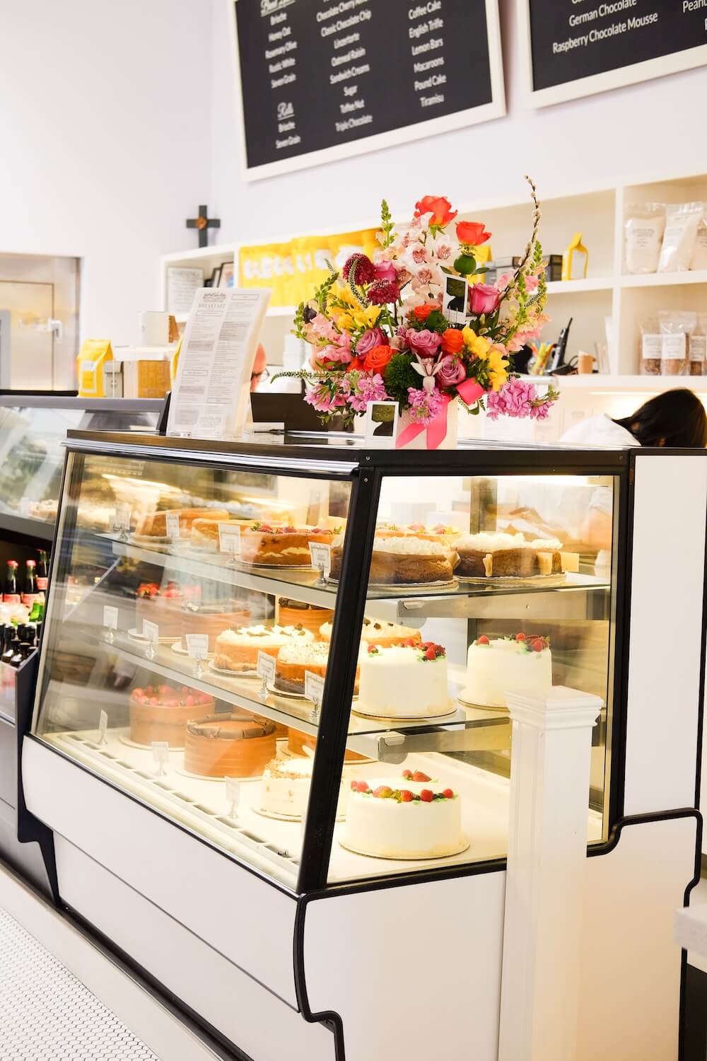 A bakery display case filled with dedicated gluten-free cakes and desserts at Lilac Pâtisserie in Santa Barbara.